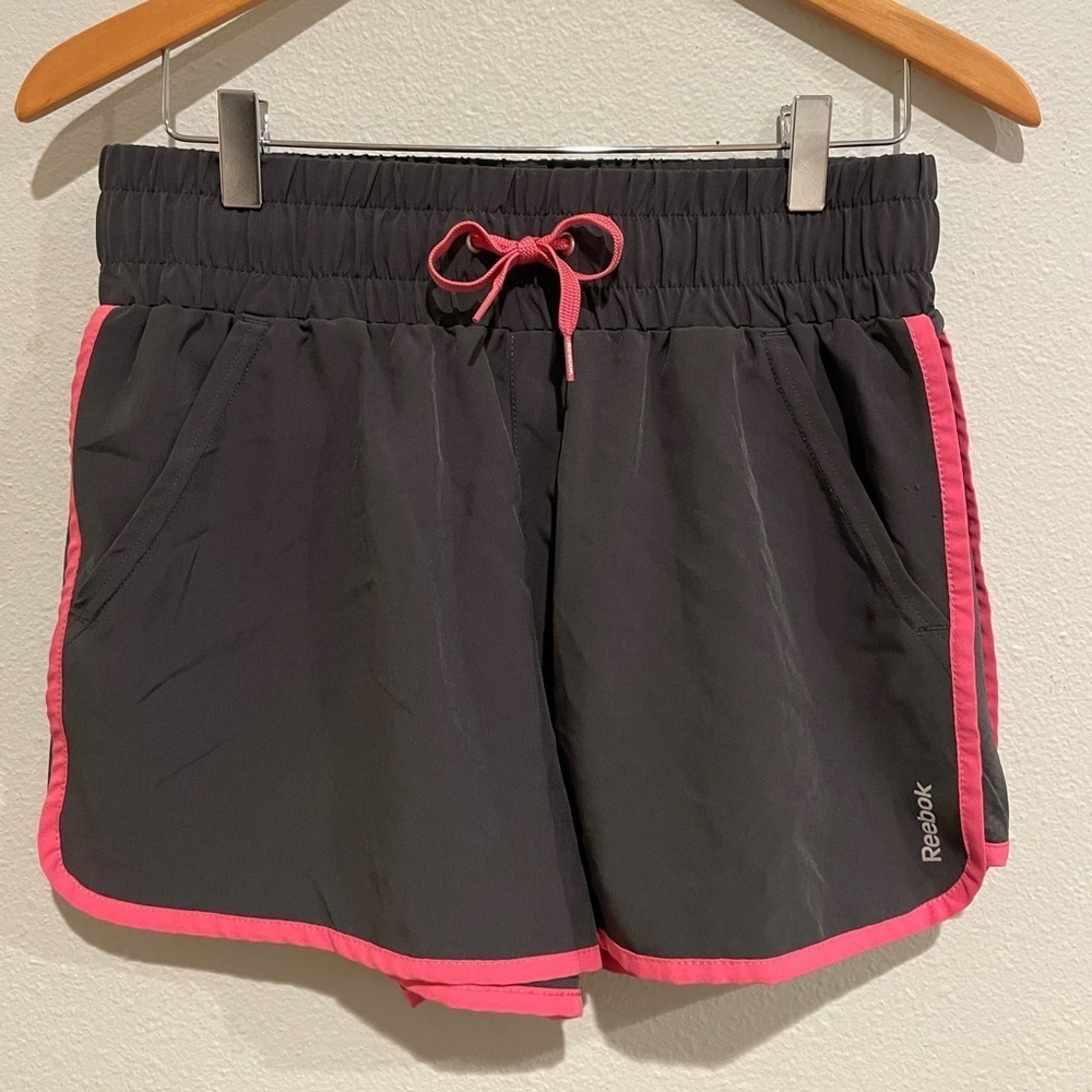 Women’s Gray with pink trim Reebok athletic shorts.  Front pockets. Size…